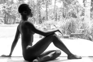 Silhouetted person seated in sunlit doorway