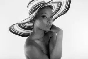 Monochrome portrait of woman wearing striped hat